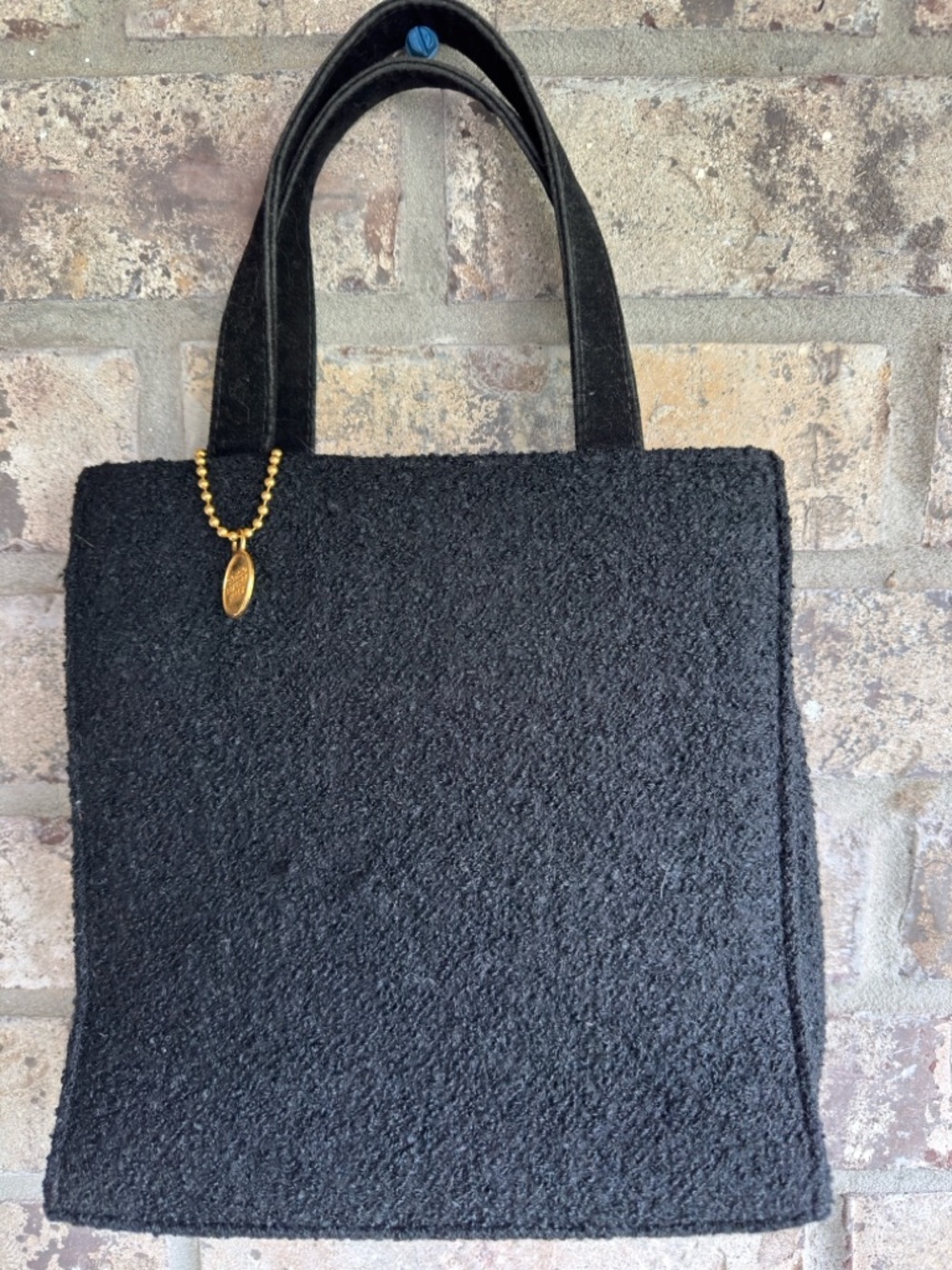 Textured Black Tote Bag with Gold Charm Accent